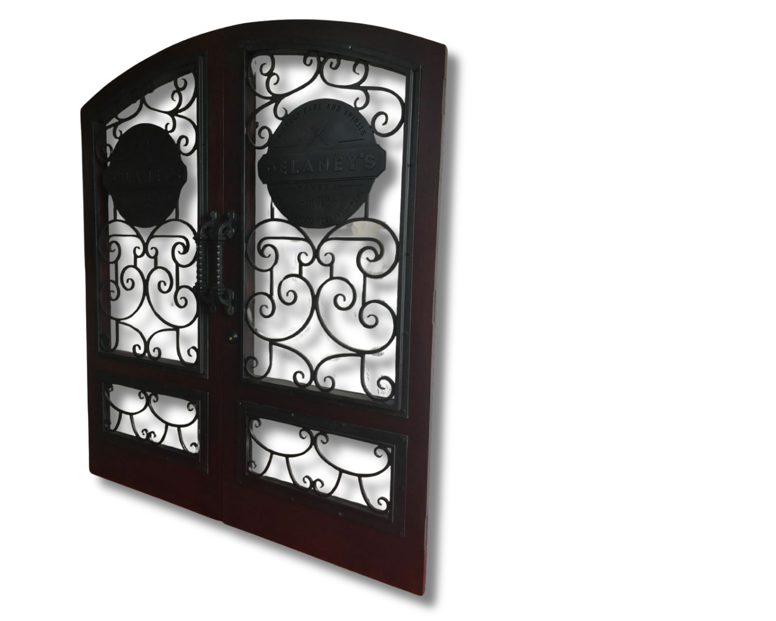 A pair of dark mahogany-stained solid wood commercial double entry doors featuring large glass panes overlaid with elaborate black wrought iron scrollwork