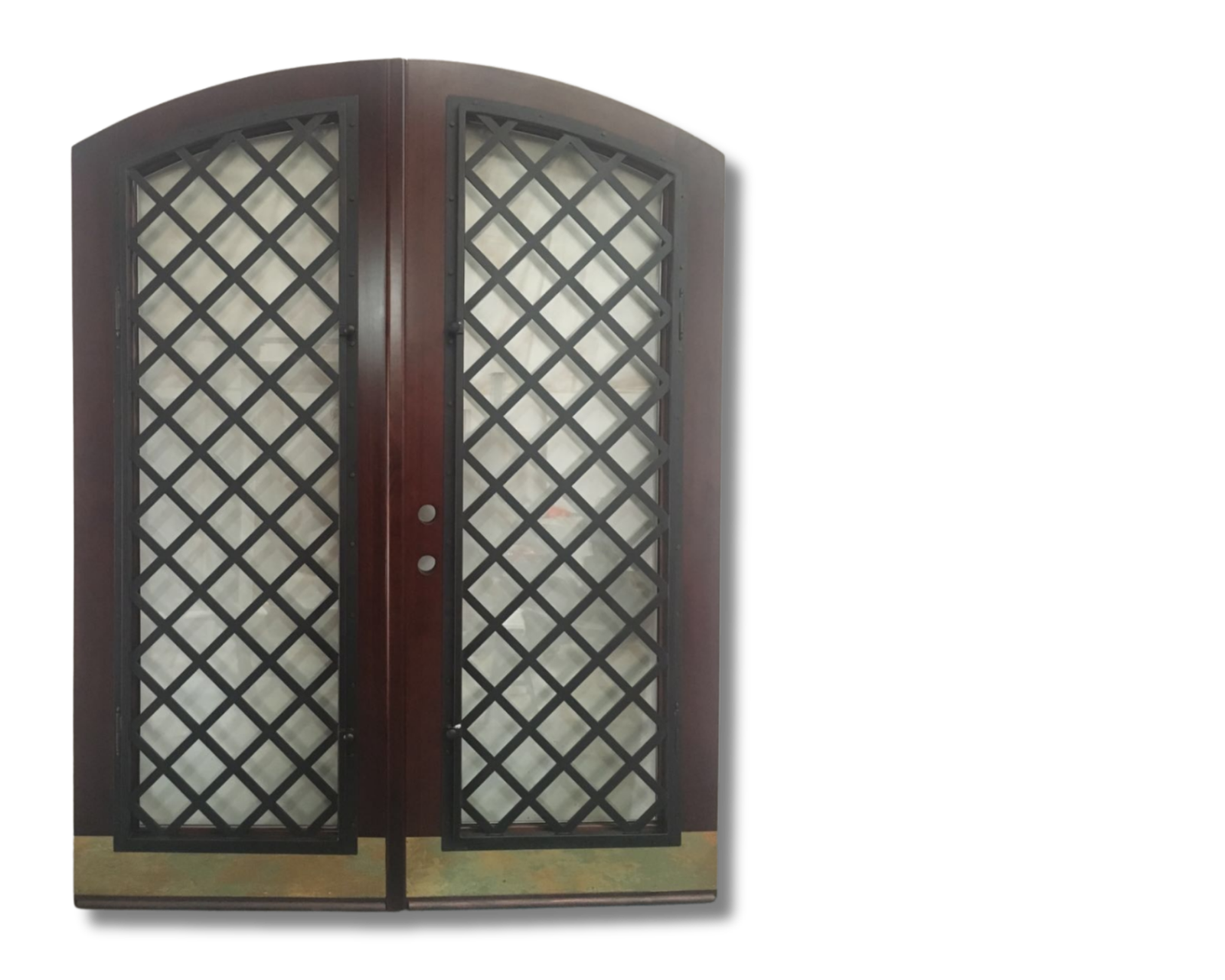 Arched dark wood double doors featuring full-length black metal diamond lattice grilles over glass, finished with weathered brass kickplates