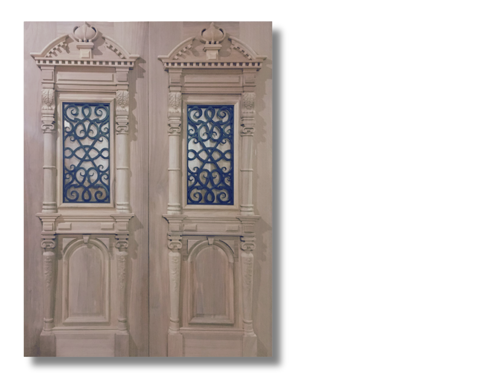 Double doors featuring intricate hand-carved classical details, crowned pediments, and decorative iron scrollwork window grilles