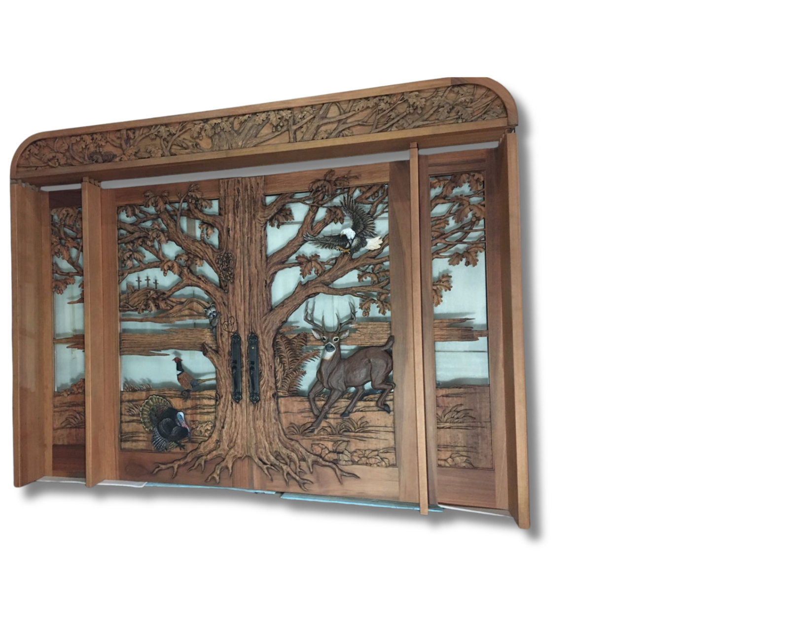 Massive custom hand-carved solid wood double entry door system featuring two matching carved sidelights and a decorative overhead transom window