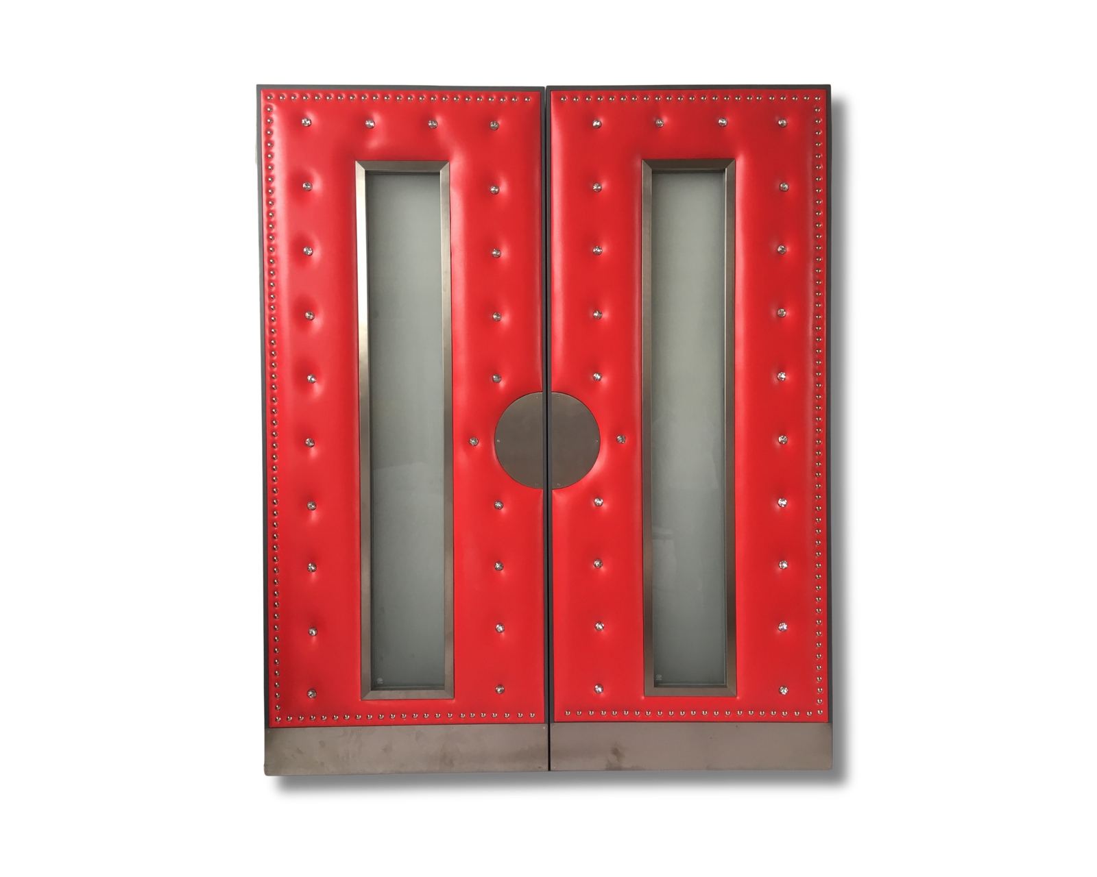 Custom bright red button-tufted double doors featuring tall vertical frosted glass inserts, decorative silver metal studs along the borders, a large central circular pull handle, and metallic base trim.