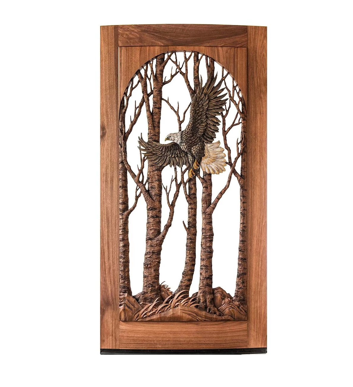 Isolated product shot of a custom hand-carved solid mahogany front door featuring a flat-top header frame and an arched glass insert with a soaring bald eagle in birch trees.