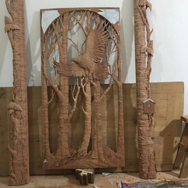 Unfinished hand-carved solid mahogany eagle insert panel displayed between two matching hand-sculpted tree trunk exterior casings with leaves and a miniature birdhouse detail.