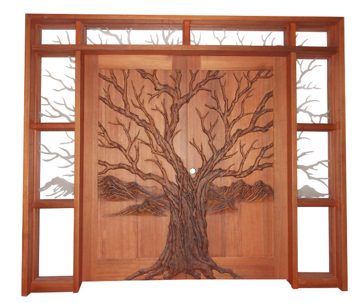 A front view of a finished, stained solid wood double entry door featuring a highly detailed 3D hand-carved oak tree and mountain landscape, flanked by matching sidelights and a top transom with custom-etched glass continuing the branch and mountain silhouette designs.