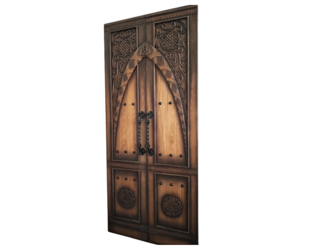 An interior back view of a luxury Gothic solid white oak double entry door system by Crown Custom Doors, isolated on a black background, showcasing matching hand-carved Celtic knots, braided relief borders, black clavos studs, and a pair of heavy-duty, hand-twisted black wrought iron vertical pull handles.
