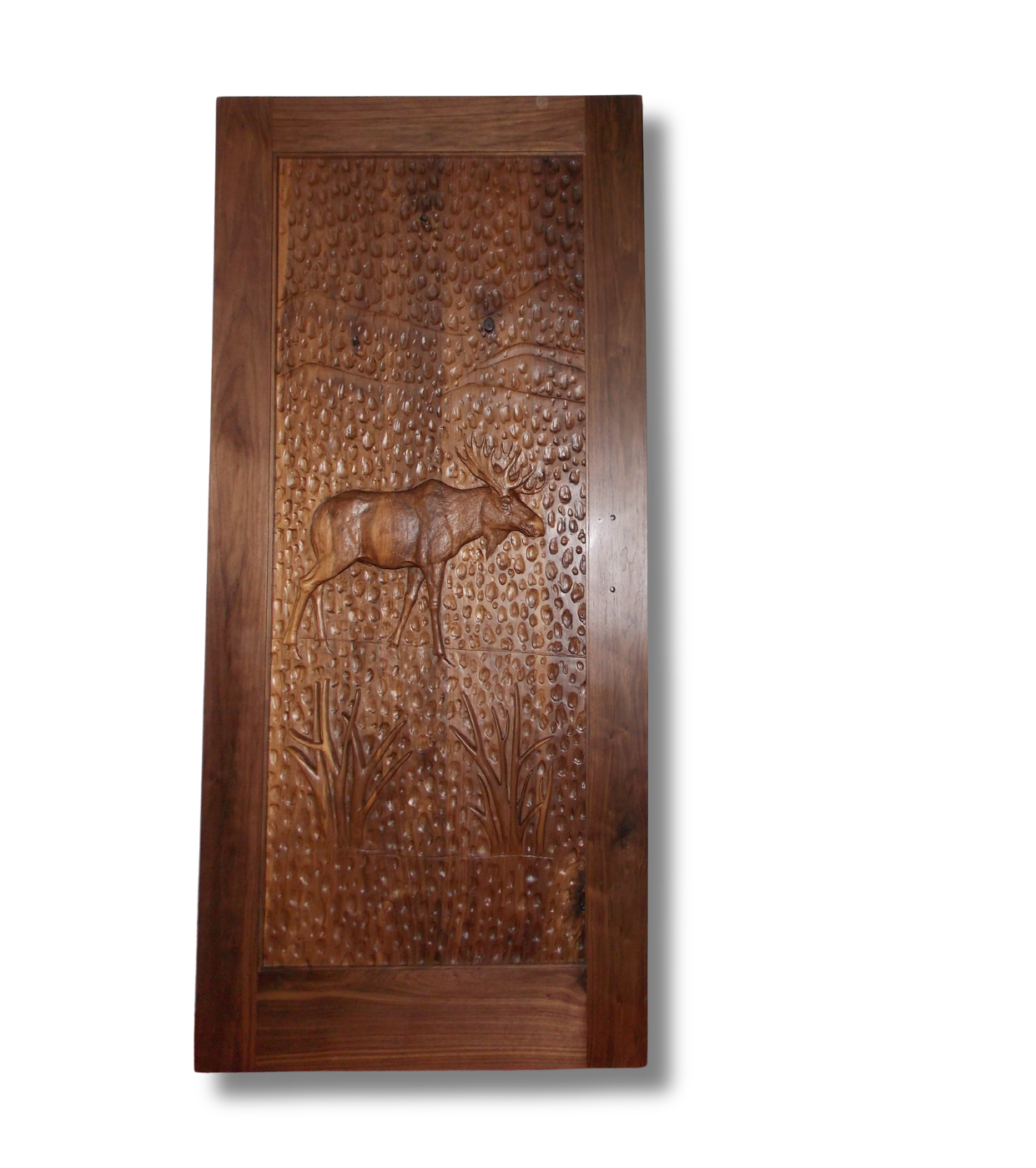 Hand-carved solid wood entry door featuring a high-relief 3D carving of a bull moose in a forest landscape with hand-chiseled adzed background texture.