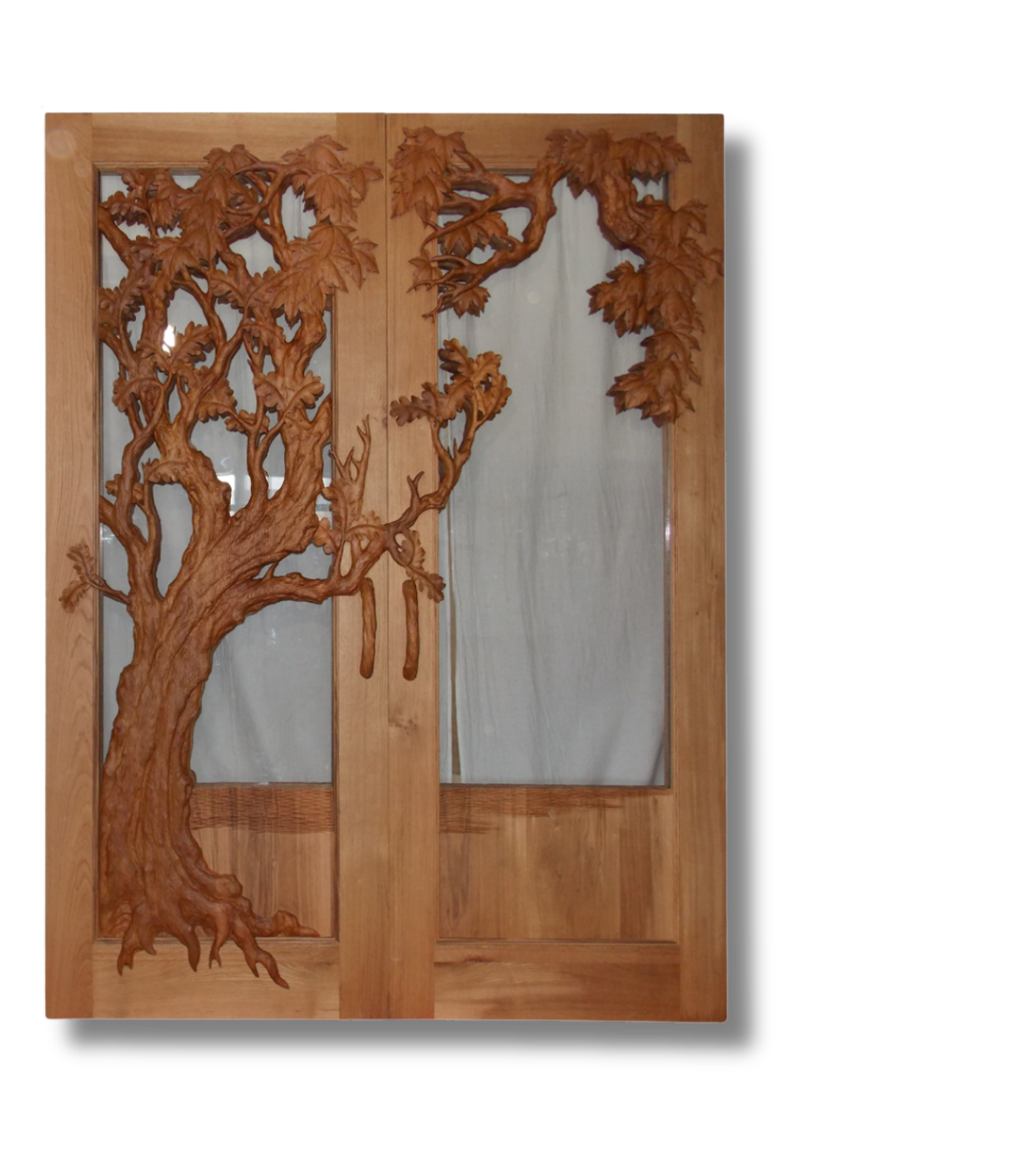 Craftsman solid wood double entry doors featuring an organic 3D relief carving of an oak tree spanning across both panels over frosted glass, complete with carved wooden handles.