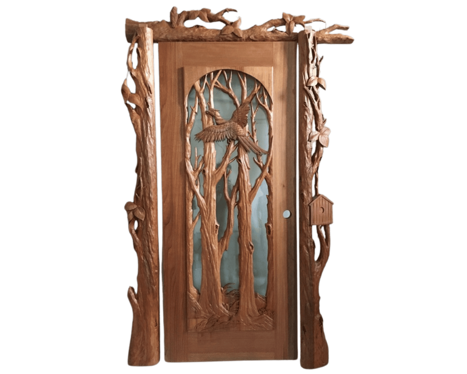 Handcrafted single solid wood front door featuring a 3D carved pheasant in flight among forest trees with matching carved branch door trim, jamb, and birdhouse accent.