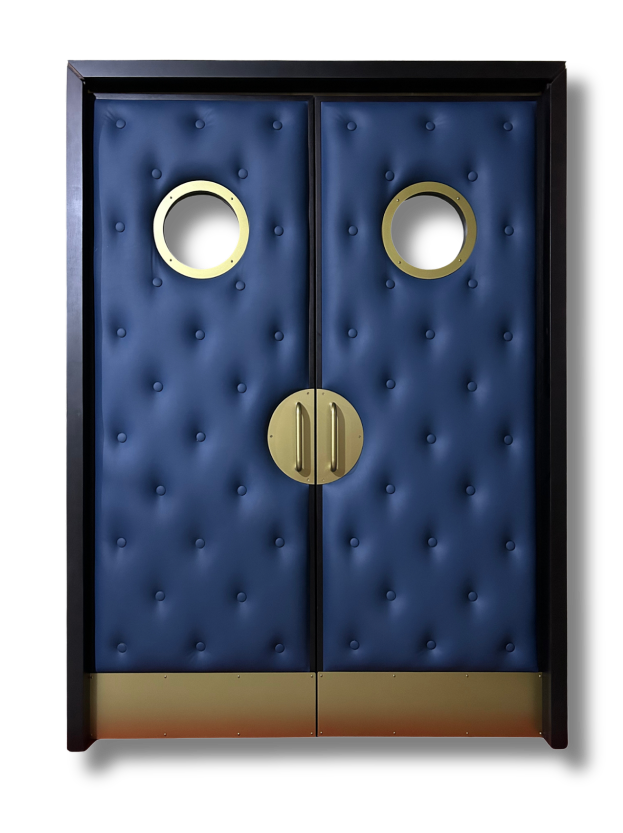Centered studio view of custom navy blue button-tufted leather acoustic home theater double doors on a black background, featuring electroplated champagne gold stainless steel porthole vision panels, half-moon pull handles, and bottom kick plates by Crown Custom Doors.