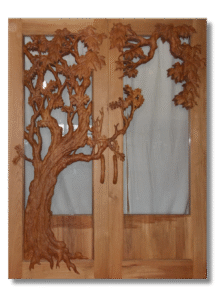 Studio view of handcrafted solid wood double entry doors featuring a 3D hand-carved oak tree with leaf clusters and branches spreading across clear glass inserts, complete with matching carved wood door handles.