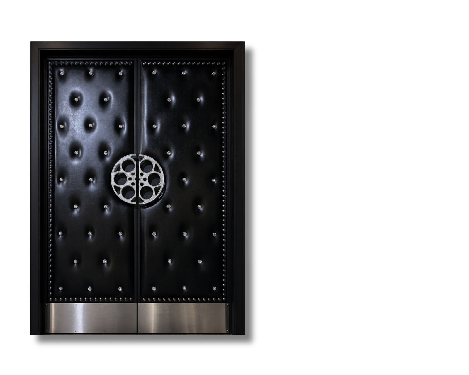 Installed custom black button-tufted vinyl acoustic home theater double doors featuring silver nailhead trim, circular silver film reel center handles, silver kickplates, and an illuminated CINEMA sign mounted above the frame.