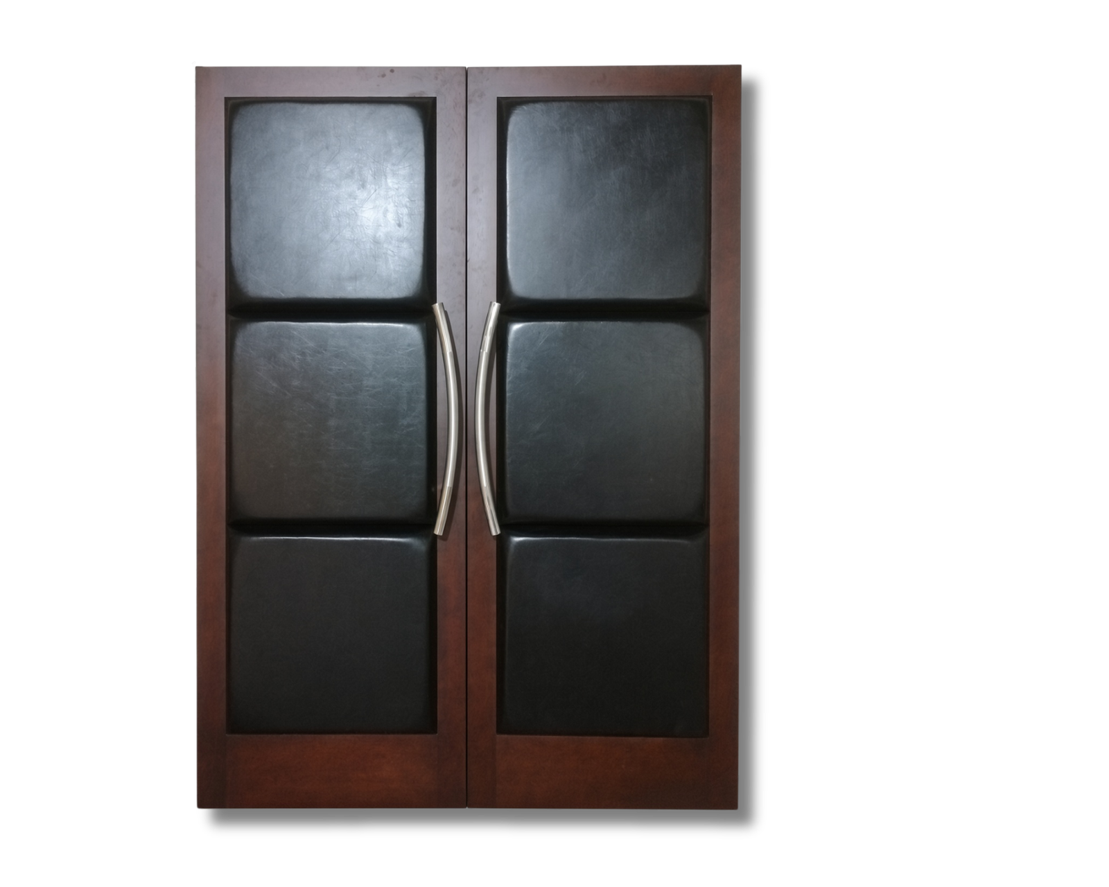 Custom mahogany acoustic double doors for a home theater, featuring padded dark leather square panels, rich warm wood frames, and sleek brushed curved pull handles by CROWNCUSTOMDOORS.