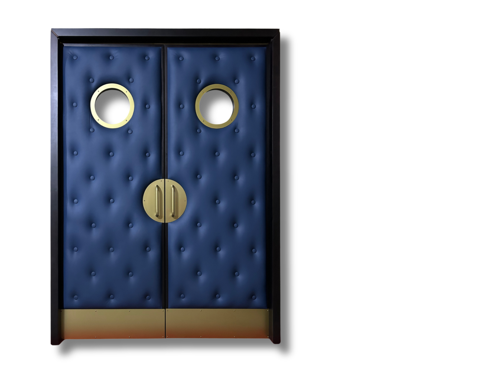 Studio product view on a clean black background showing custom navy blue button-tufted leather double home theater doors with champagne gold electroplated portholes, half-moon pull handles, and kick plates by Crown Custom Doors.