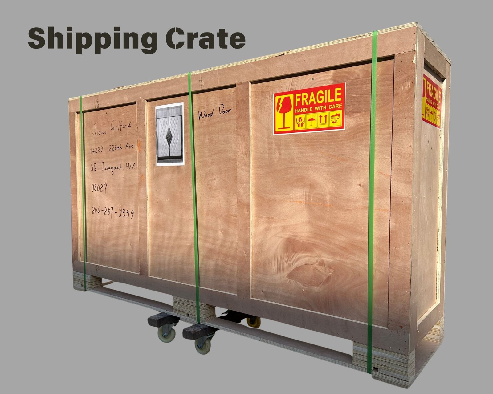 Custom wooden shipping crate built for secure freight transport of hand-crafted solid wood and upholstered double doors, featuring fragile warning labels, protective strapping, and integrated pallet skids.