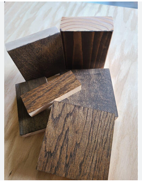 Selection of custom hardwood blocks featuring dark Jacobean wood stain finishes showcasing grain patterns across different lumber species by Crown Custom Doors.