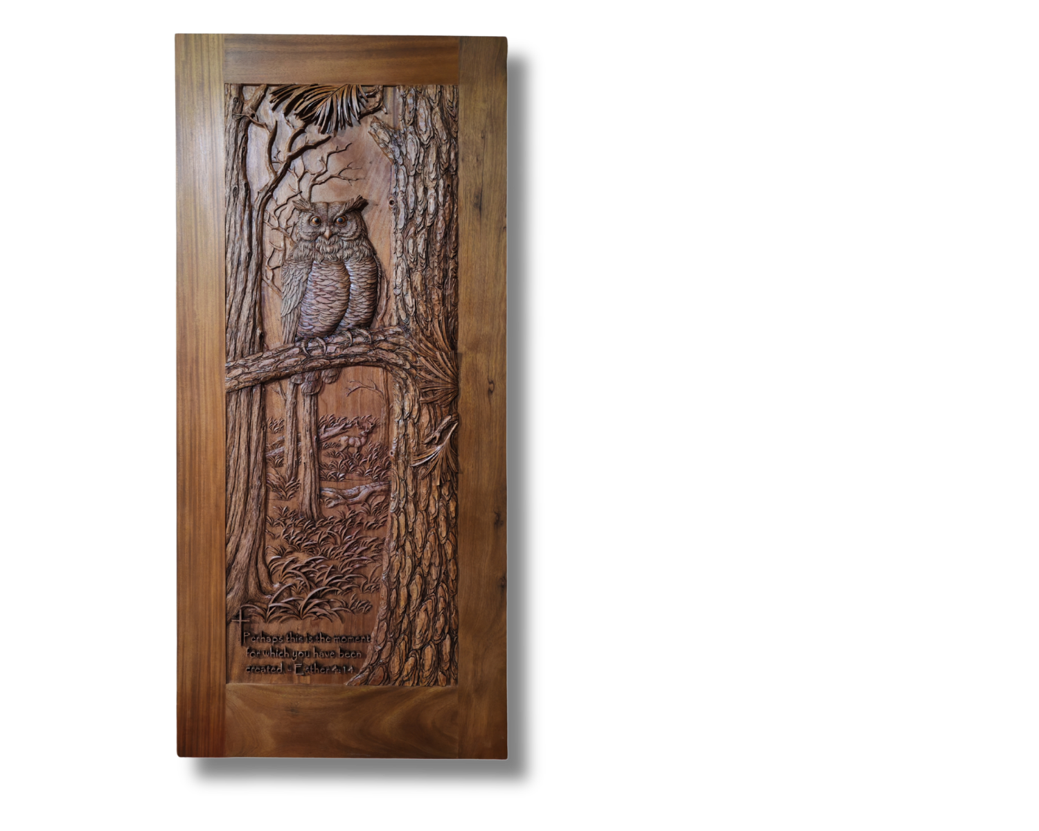 Full studio view of a custom solid wood entry door featuring a deeply hand-carved horned owl perched on a branch, forest background relief, and a carved scripture verse inscription at the bottom.